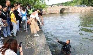 游客玩手机掉西湖